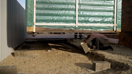 Building modular house foundation with concrete blocks