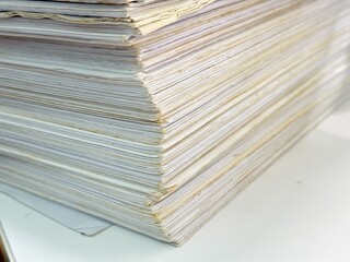 Piles of old papers were stacked on top of each other.