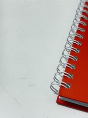 Red spine of the notebook.