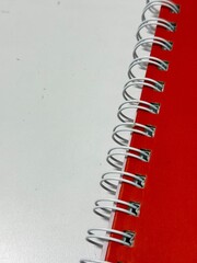 Red spine of the notebook.