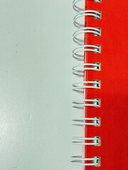 Red spine of the notebook.