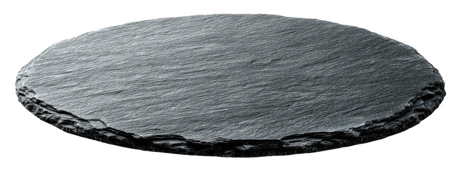 A round, dark gray, rough-edged, slate-like serving board floating on a black background