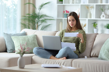 Relaxed woman doing online accounting with laptop