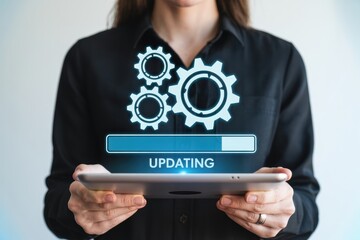 A woman in a black shirt holding a tablet with an updating progress bar and gears on the screen