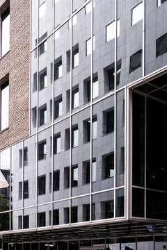 Modern urban office building exterior with corporate entrance, facade windows and clean architecture for business headquarters and professional branding