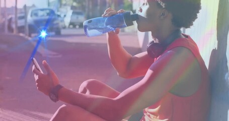 Man drinking water and checking smartphone on urban sidewalk, with animated fitness graph overlay - Powered by Adobe