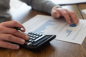 Investment and budget planning, Close up of male hand using calculator for business finance analysis and accounting
