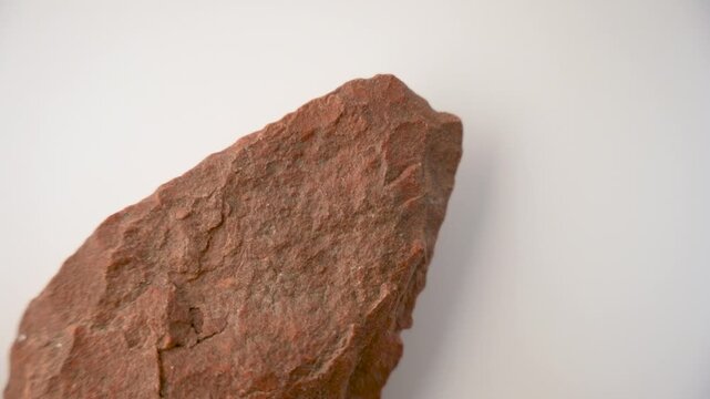Prehistoric stone point. Spear. White background. Lower Paleolithic. Homo heidelbergensis. Hunting, super slow motion video at 100 fps