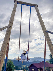 Woman Swinging Over Scenic Carpathian Mountain Landscape
