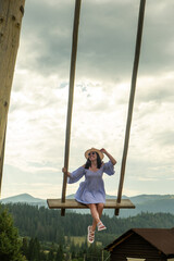 Woman Swinging Over Scenic Carpathian Mountain Landscape