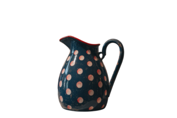A ceramic pitcher with pink polka dots on a black background