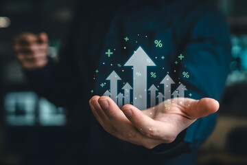 Business growth concept with hand holding rising arrows and percent symbols floating above palm
