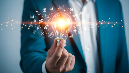 Innovative idea and business concept in a hand holding a glowing lightbulb with icons symbolizing different industries