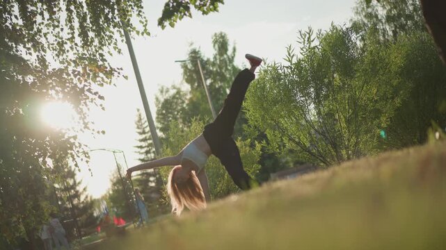 white woman doing cartwheel in park with golden backlight, dynamic dance flow, red sneakers, handstand transitions, motion blur, playful energy, urban greenery, late afternoon practice, candid