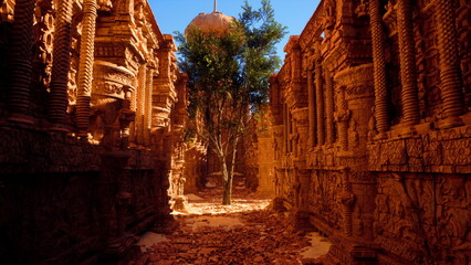 Fototapeta premium Visitors wander through stunning ancient ruins filled with detailed carvings, where a lone green tree stands against warm, sunlit stone, offering a contrast of color and life in a timeless landscape.