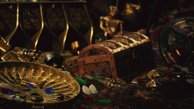 A rich collection of gold coins and gemstones sprawls across a dark surface. Ancient artifacts and a treasure chest add to the mystique of this hidden trove.
