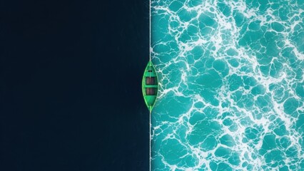 Green boat sails through contrasting ocean waters with white sea foam