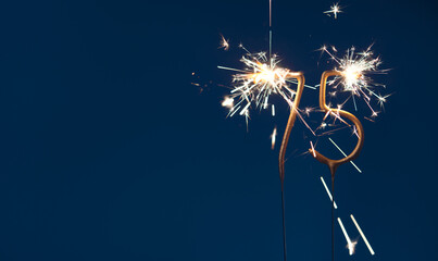 75 years anniversary celebration festive background made with Bengal fires in the form of number Seventy five.