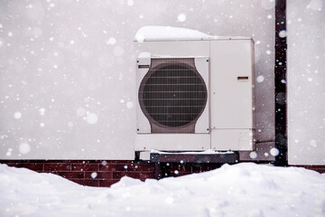 Heat Pump in Winter with Snowfall and Cold Temperature. Heat Pump Efficiency Electric Heater of...