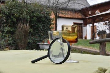 Magnifying glass and vintage glassware outdoors
