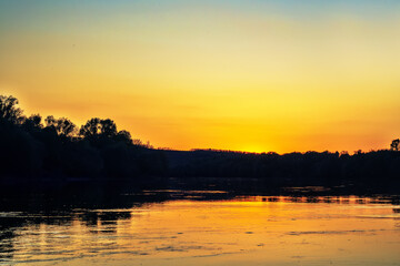 The colors of the sunset over the big smooth river Don, streamline flow but whirlpools and counterflow. Russia
