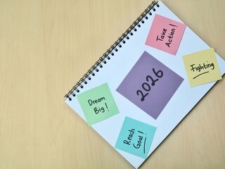 2026 New year resolutions and goal setting concept on colorful sticky note and notebook. Perfect for concepts related to planning, inspiration, and future aspirations