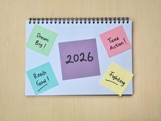 2026 New year resolutions and goal setting concept on colorful sticky note and notebook. Perfect for concepts related to planning, inspiration, and future aspirations for the upcoming year