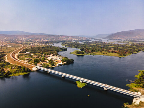 Aerial view of the Adomi Bridge stretches gracefully across the Volta River, a ribbon of steel and concrete against the water, Akosombo, Eastern Region, Ghana.