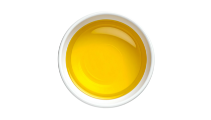 Top-down view of a small white bowl filled with glistening golden liquid against black background