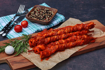 Grilled skewers: Slices of pork belly wrapped on skewers with tomatoes and spices.