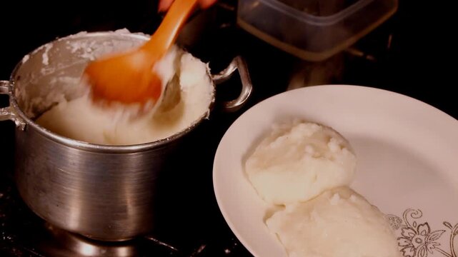 Corn or maize flour pap, a staple food in many countries in Africa being served in a round scoop
