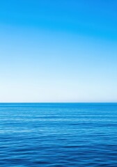 Obraz premium Beautiful vast open ocean and deep blue sky meeting perfectly at the distant horizon line during the bright day. Nature background, freedom, curve, ocean
