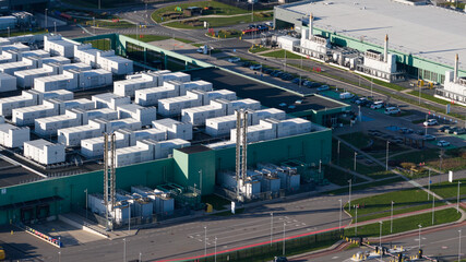 Aerial view of a sprawling data center complex casting long shadows under the afternoon sun, Agriport, Middenmeer, Netherlands.