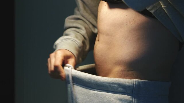 A person with an itchy body is wearing oversized pants.
Motivation to exercise.
An active and athletic lifestyle.
A person pulls down their secret sweatpants and shows off their workout results.