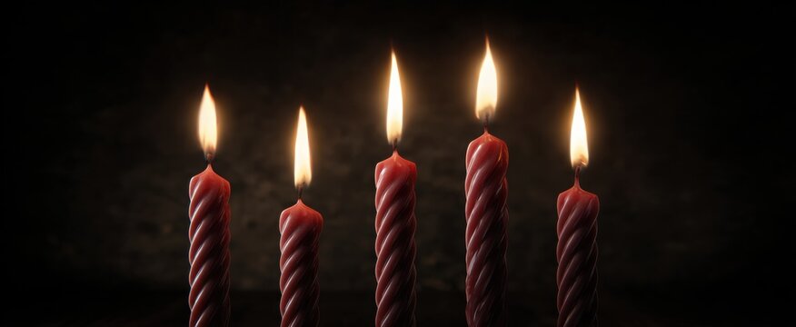 twisted candle wicks glow softly with shadows swaying in dwindling heat