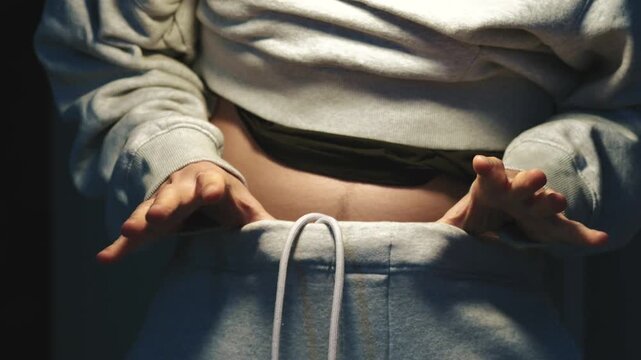 A person who has lost weight is wearing a large clothing size.
Weight loss and diet.
A person pulls down his pants and shows how much weight he has lost.