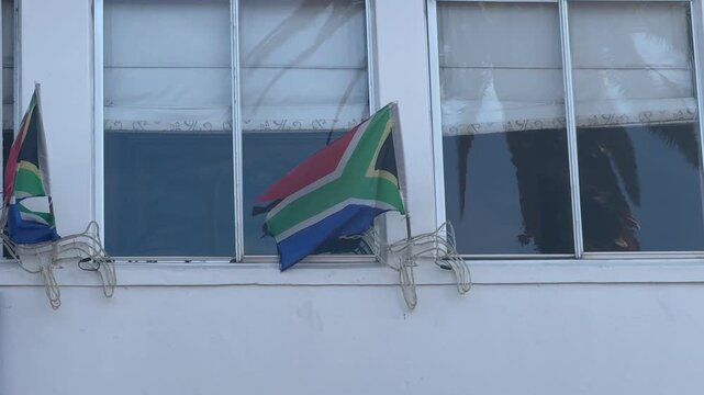 A South African flag in a window of an apartment in Cape Town, South Africa.