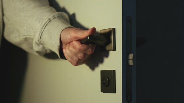 A man's hand opens the door to the convent