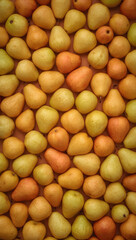 Yellow and orange pears, densely arranged. Suitable for food blogs, recipes, or fruitthemed designs. Vibrant and textured.