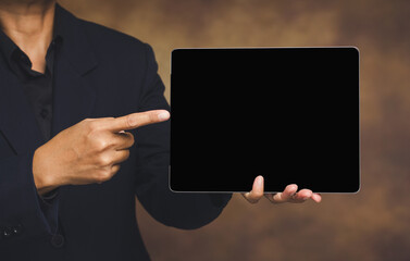 Business person pointing at blank digital tablet screen for presentation