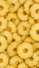 Cluster of numerous golden pineapple slices. Perfect for tropical themed designs, food blogs, or healthy recipe articles.