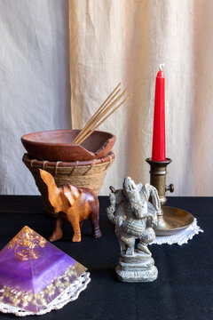 meditation altar with Ganesh, orgonite pyramid, incense and elephant
