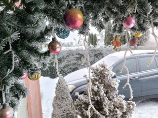 Decorating the house porch and a snow-covered car for Christmas