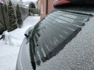 The rear window of the car is heated and defrosted from frost, side view