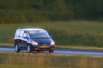 Fototapeta premium Large MPV family car driving through countryside view