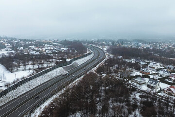 Traffic on winter highway near forest