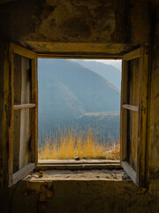 Picturesque view of mountain village from open window of rural house on cloudy day in Yerevan, Armenia. High quality photo