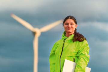 Young woman outdoors holding laptop computer