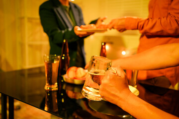 A blurry image of businessmen at a lavish office party.