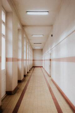 Empty corridor with bright lighting and tiled floor